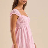 Woman wearing a pink off-shoulder dress